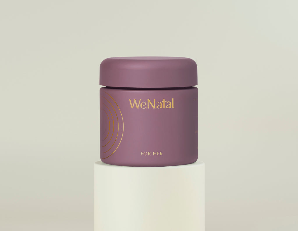 WeNatal For Her Welcome Kit jar with gold lettering, showcasing a clean design, containing 90 capsules aimed at women's wellness, set on a white pedestal.