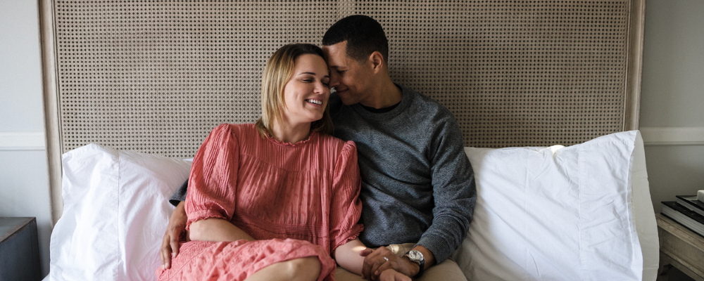 couple sitting on bed together