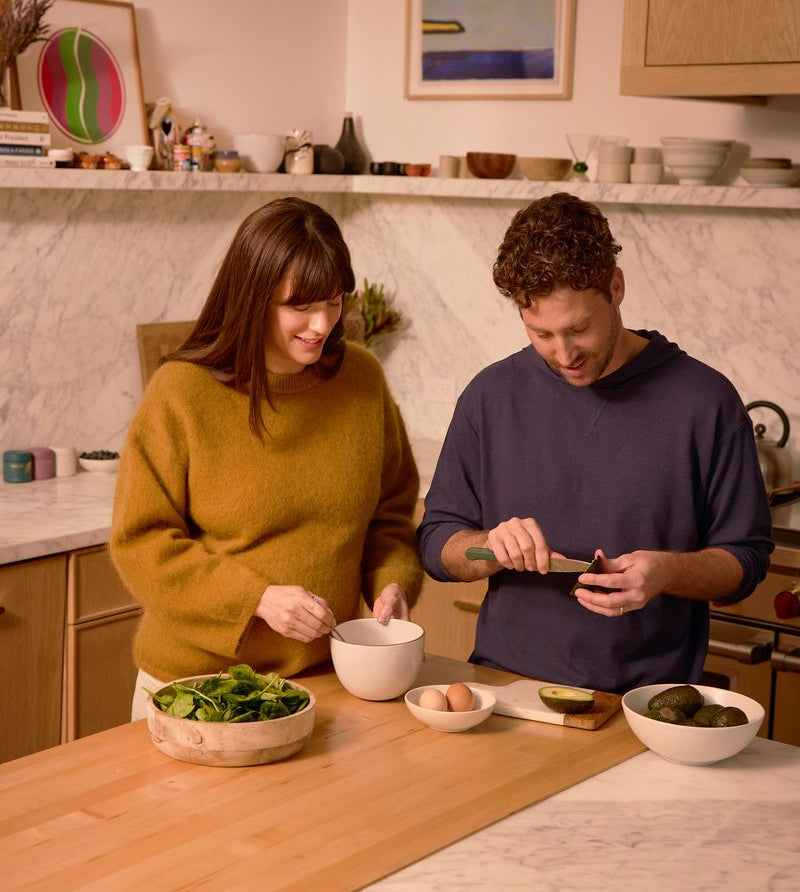 couple in kitchen making blood sugar balancing meal with protein fiber and healthy fats - WeNatal pregnancy nutrition