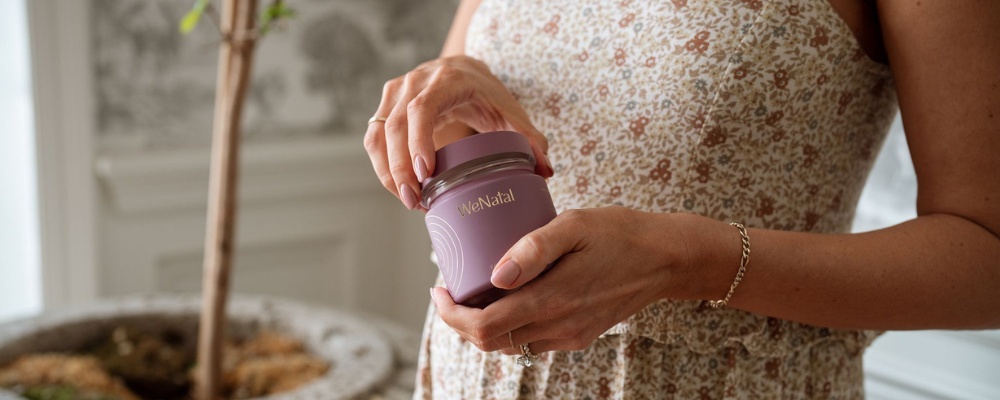 woman holding jar of wenatal prenatals for women