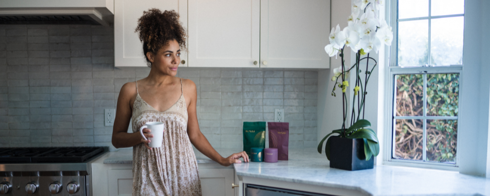 woman in kitchen looking out window - healthy diet is not enough for fertility - nutrient deficiencies in fertility