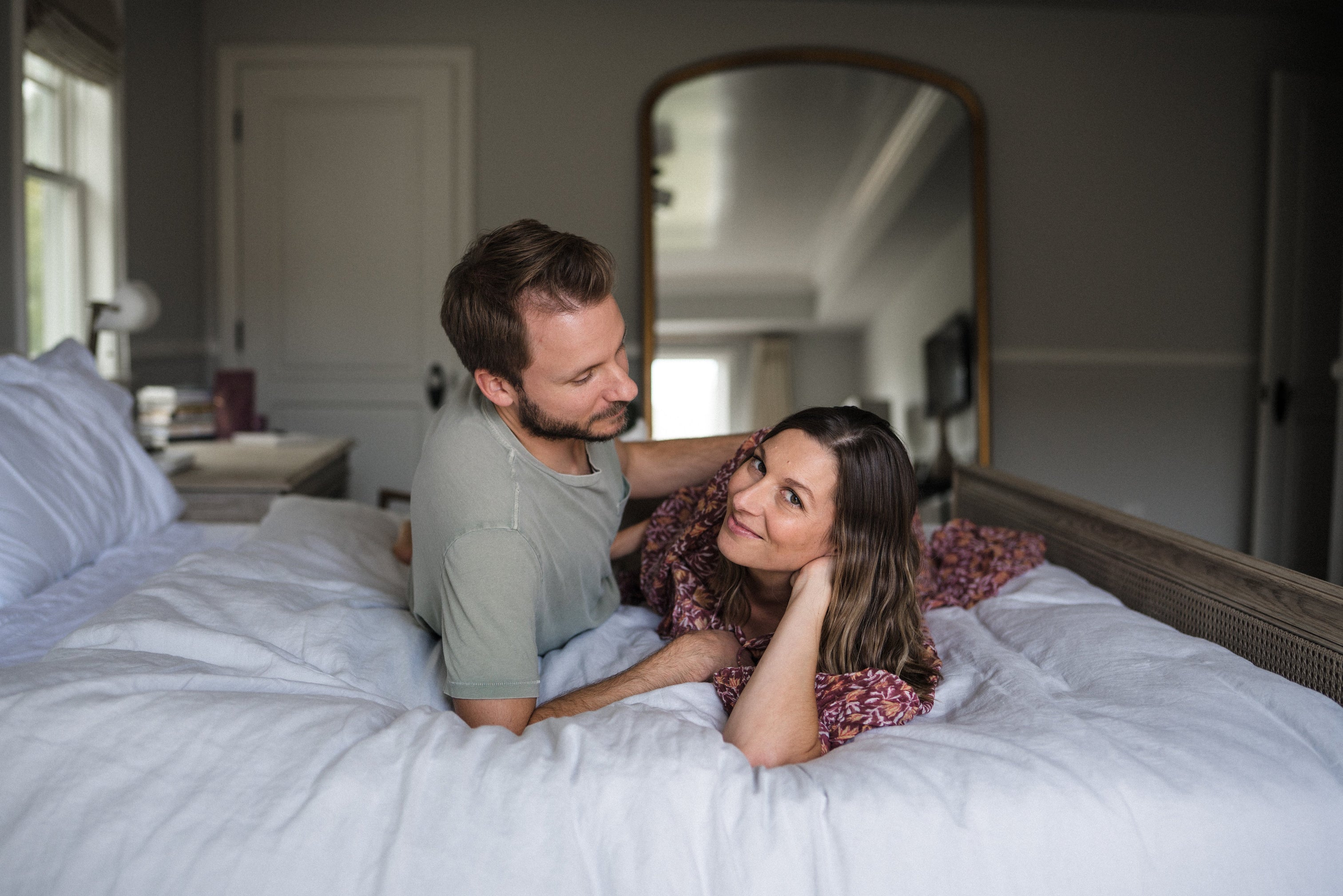 couple laying in bed - ovulation and hormone tracking for conception - WeNatal prenatal