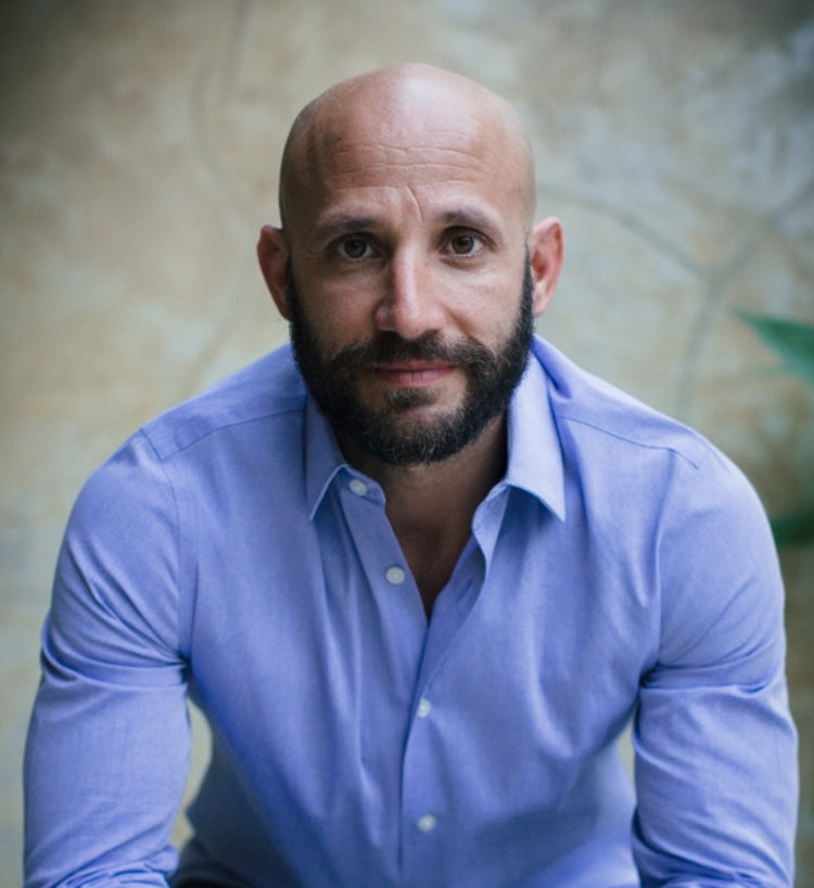 A bearded man in a dress shirt, representing WeNatal's focus on prenatal health and wellness products for men and women.
