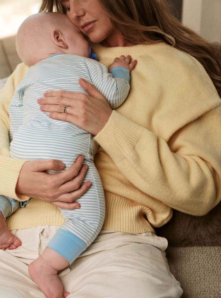 mother holding sleeping baby - WeNatal postpartum support