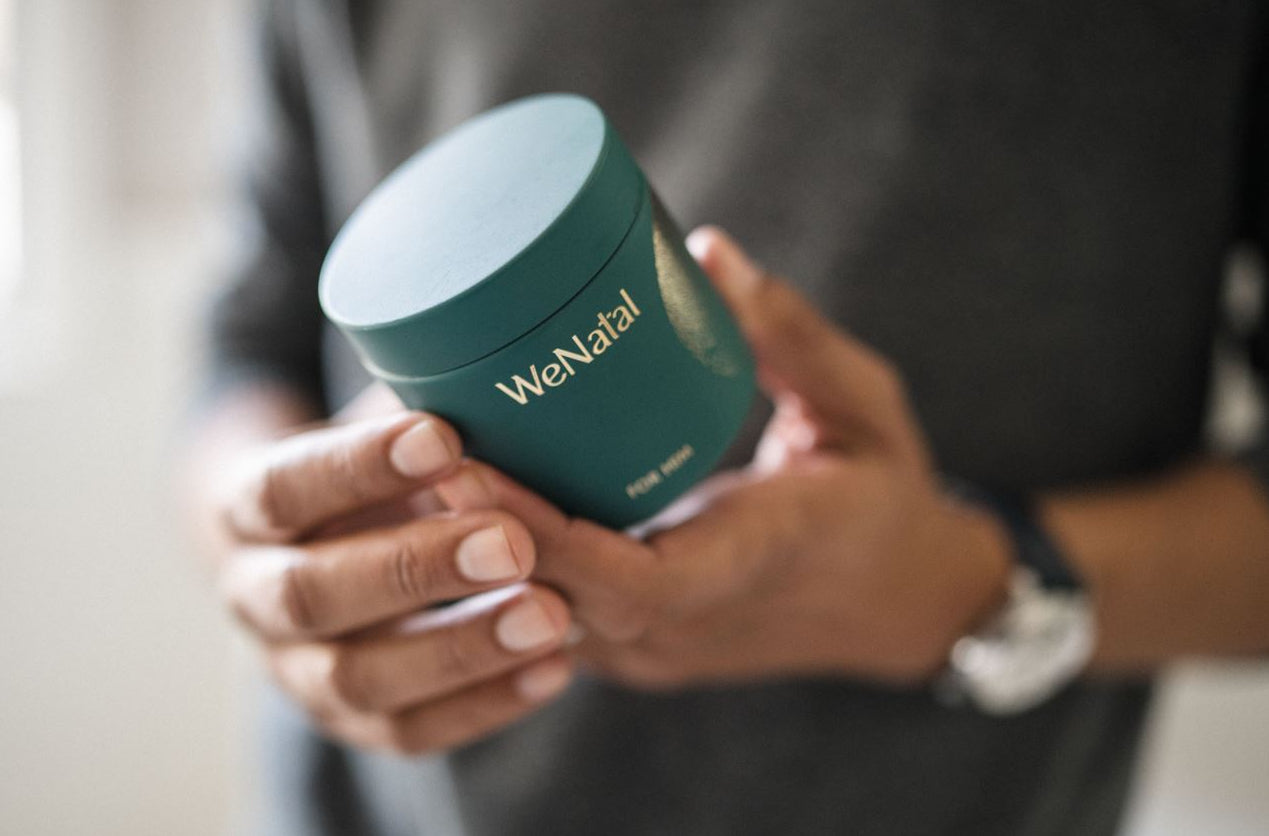 man holding glass supplement jar - WeNatal male fertility supplement - WeNatal prenatal