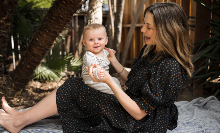Mother play with baby on lap - WeNatal Prenatal