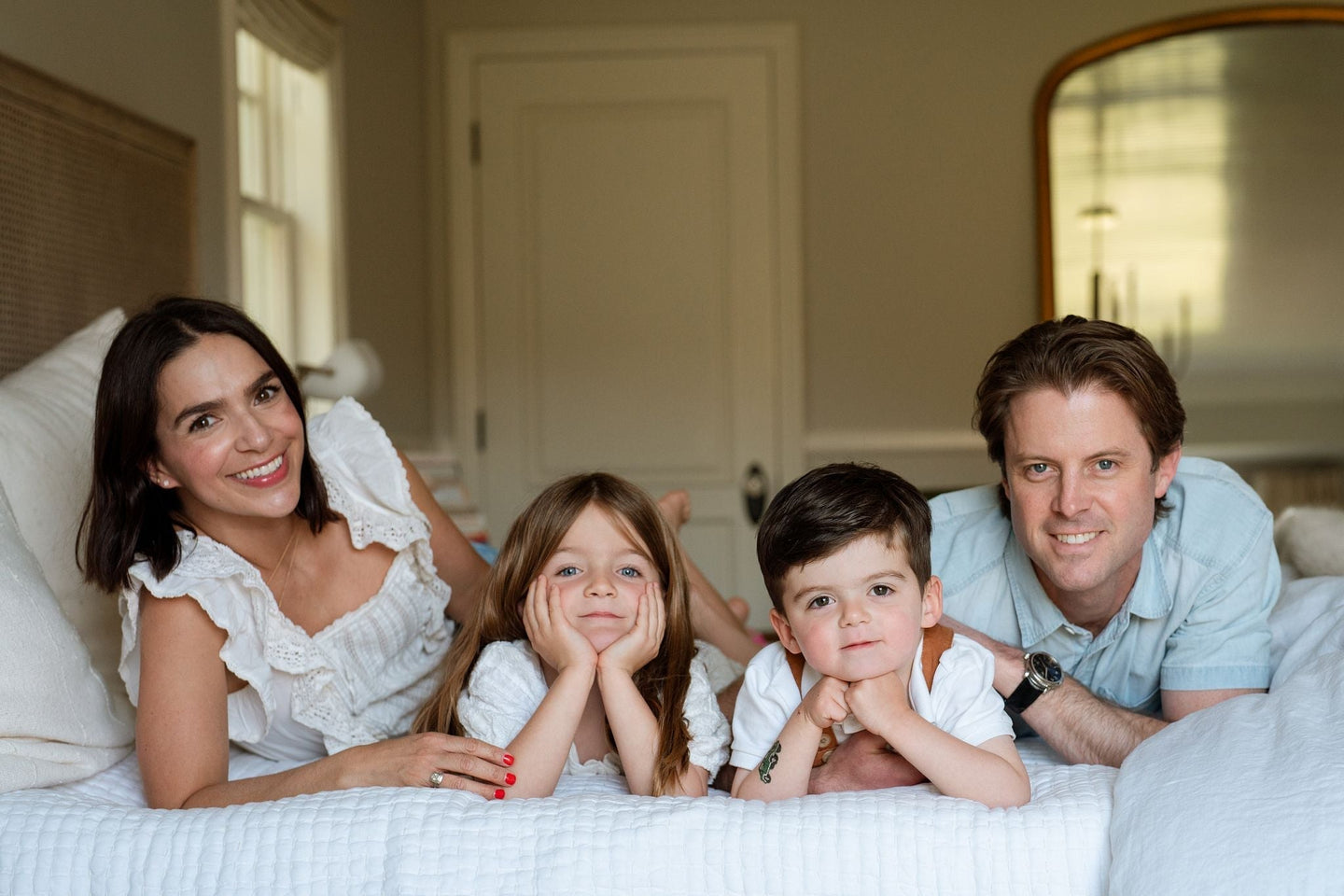 A family smiling together indoors, capturing a moment of joy and comfort, reflecting the familial focus and wellness ethos of WeNatal.