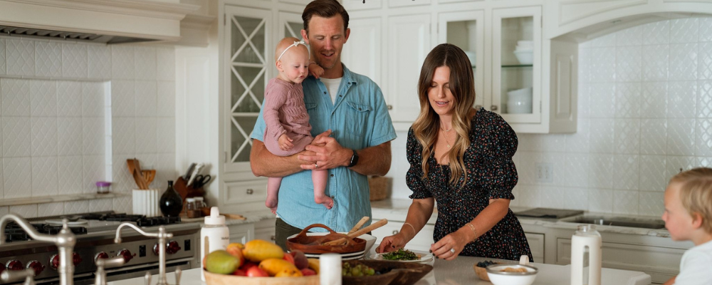 family in kitchen with mother dishing food out to her family - WeNatal protein