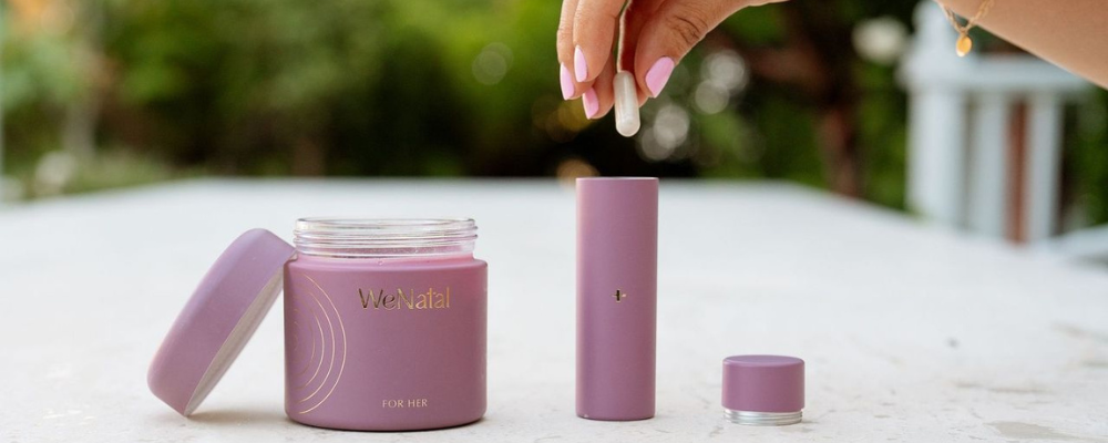 Woman placing WeNatal prenatal vitamins for women into a travel vial - WeNatal