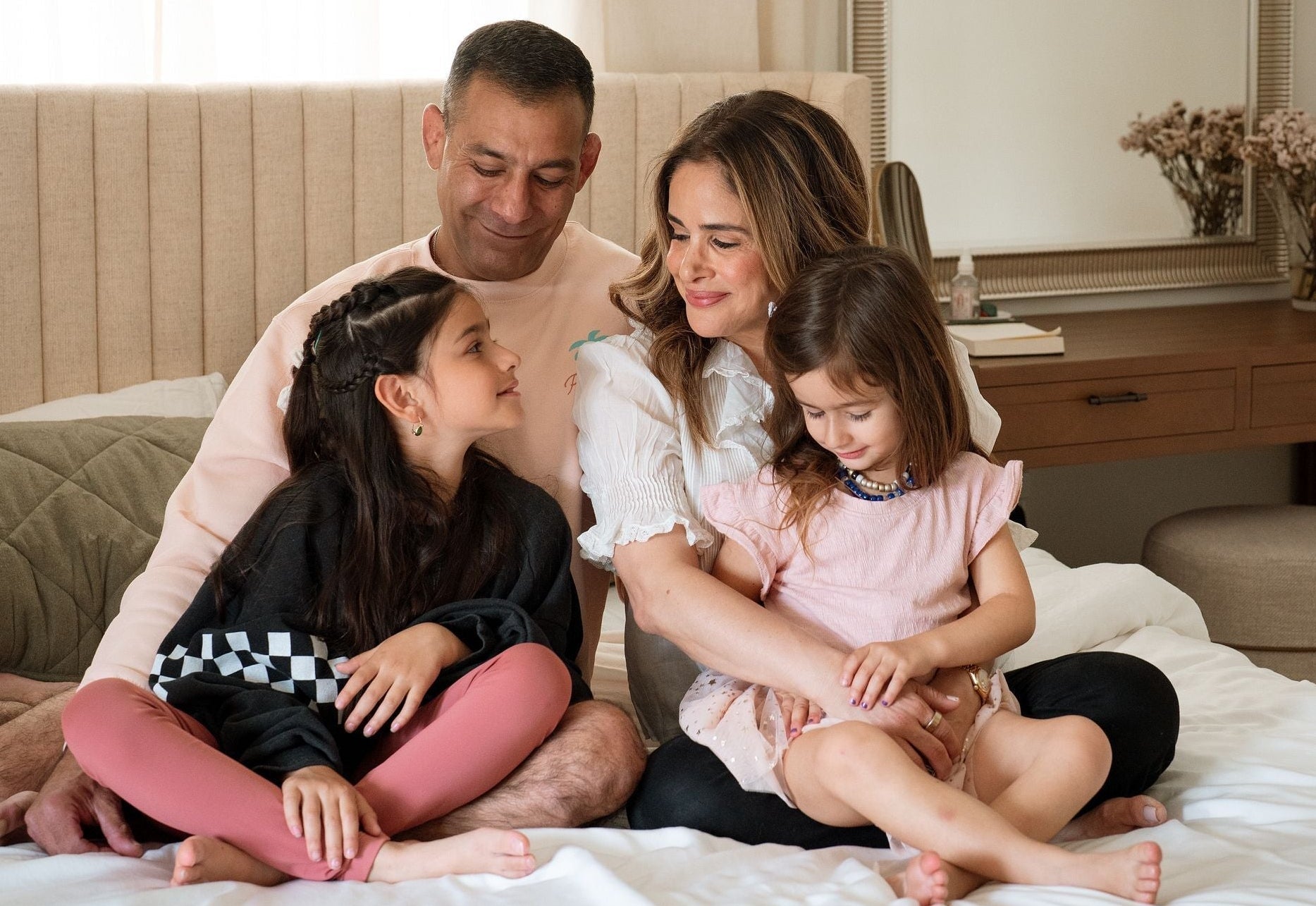  Uri and Ronit with their daughters cozy on the bed - pregnancy loss partner perspective - WeNatal for Him