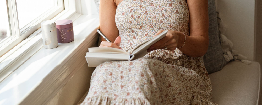 Woman writing in wenatal journal