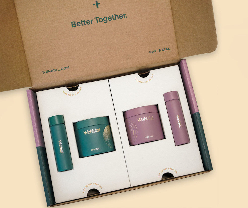 A cardboard box containing WeNatal prenatal vitamins and supplements, including a purple container and a green container with gold text, displayed prominently.