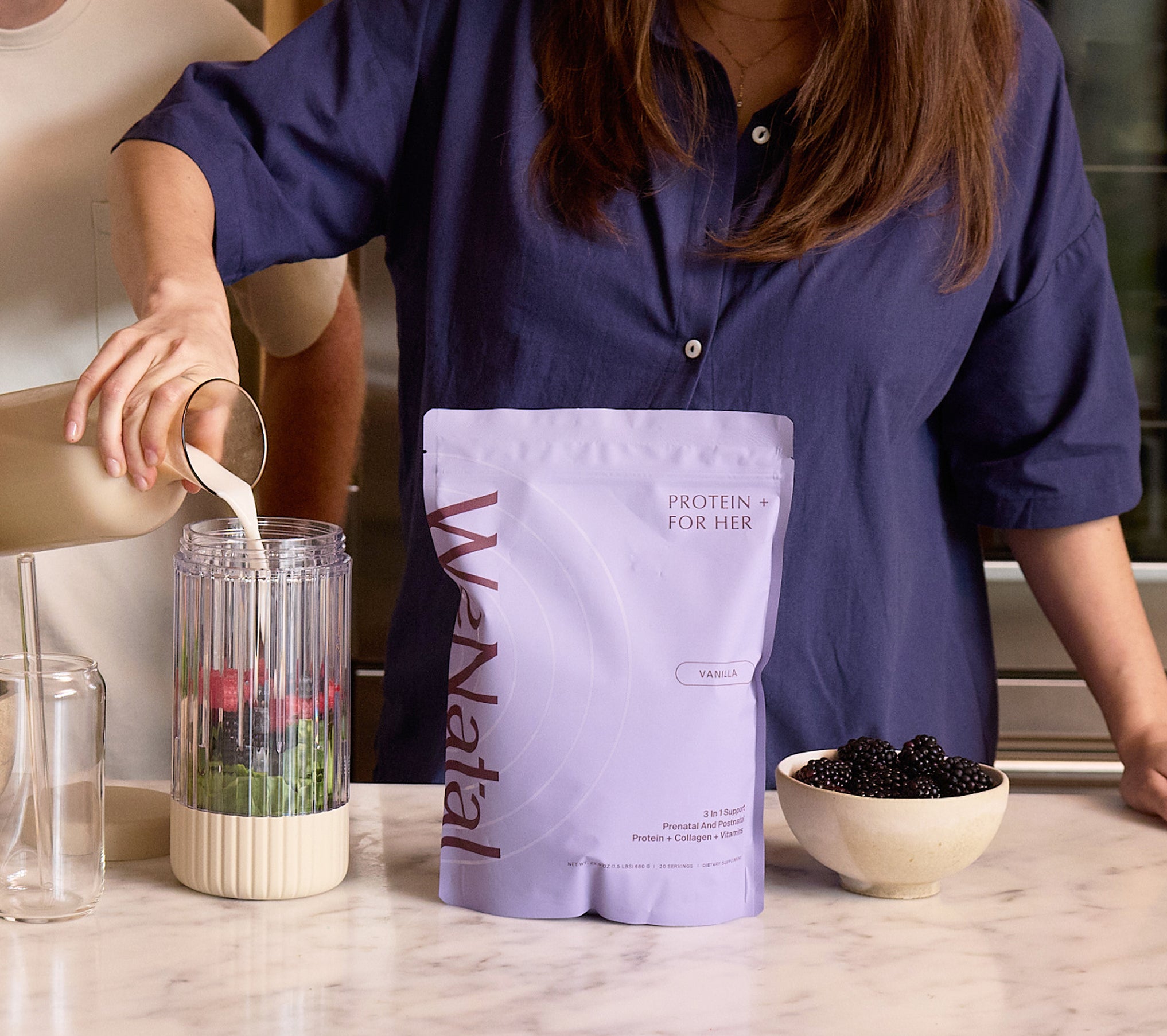 A person prepares a smoothie using WeNatal Prenatal Protein+ for Her, featuring vanilla flavor, providing daily nutrient and fertility support with essential nutrients