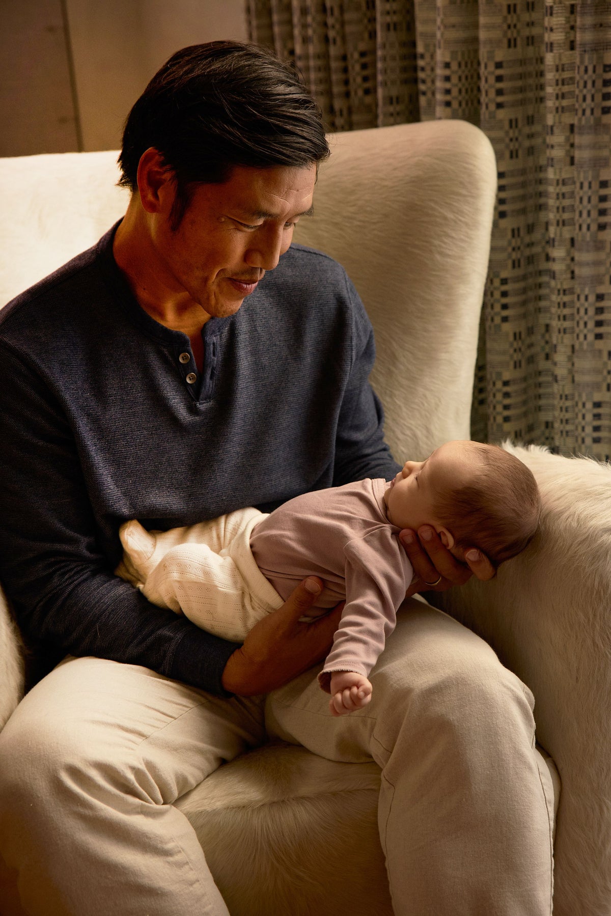 new father holding baby gazing down lovingly - WeNatal male fertility supplement