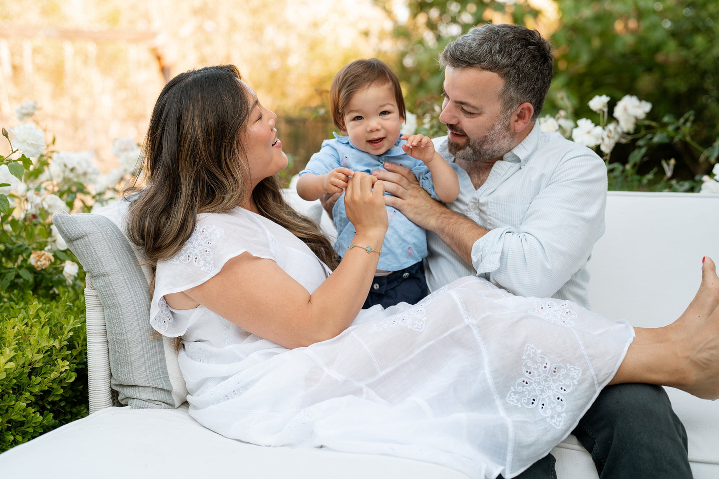 family sitting with baby outside