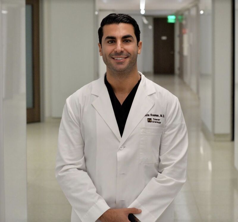 Dr Justin Houman in white lab coat