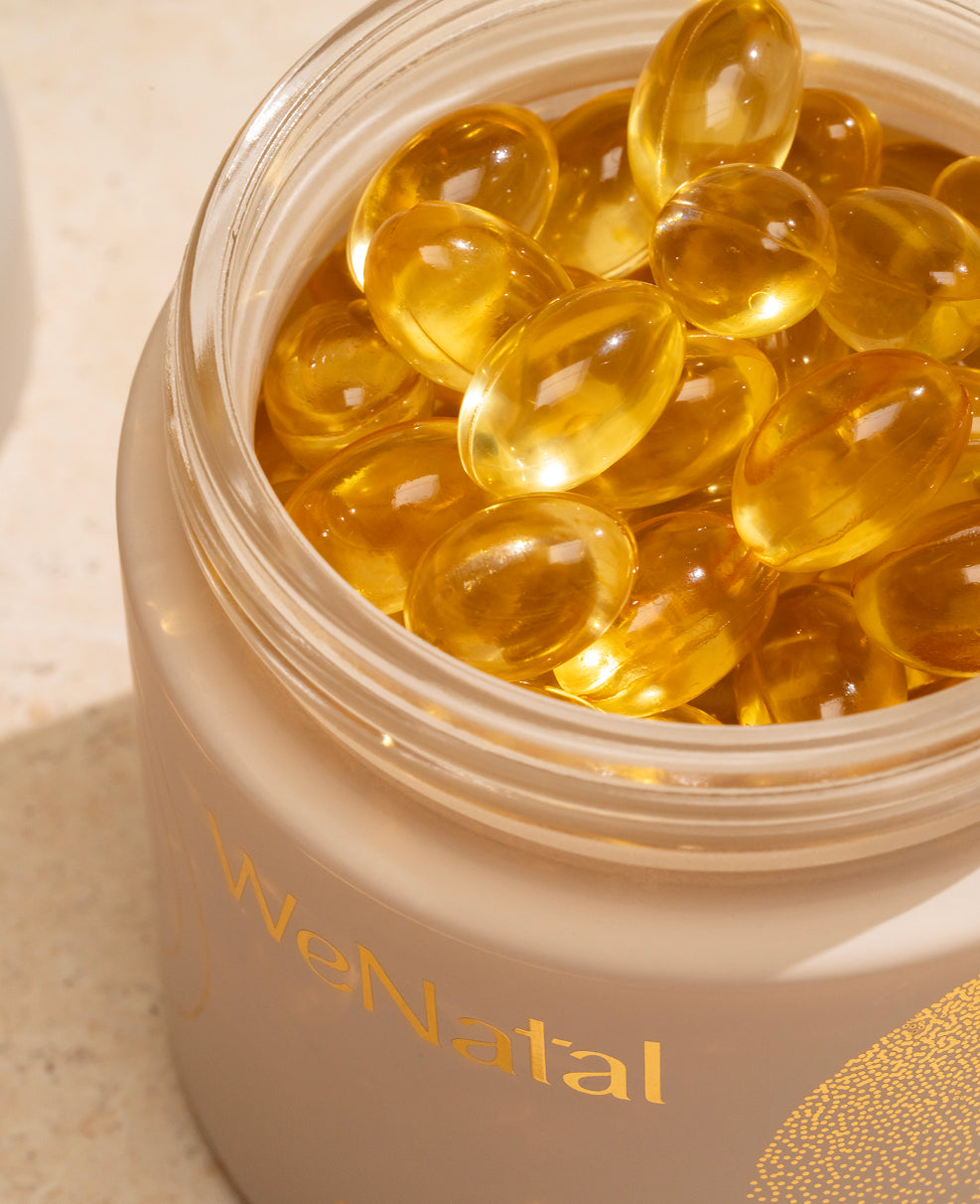 WeNatal Omega DHA+ Welcome Kit features a translucent jar of yellow-gold soft-gel capsules, providing a 30-day supply of prenatal nutrition and omega-3 DHA nutrient support