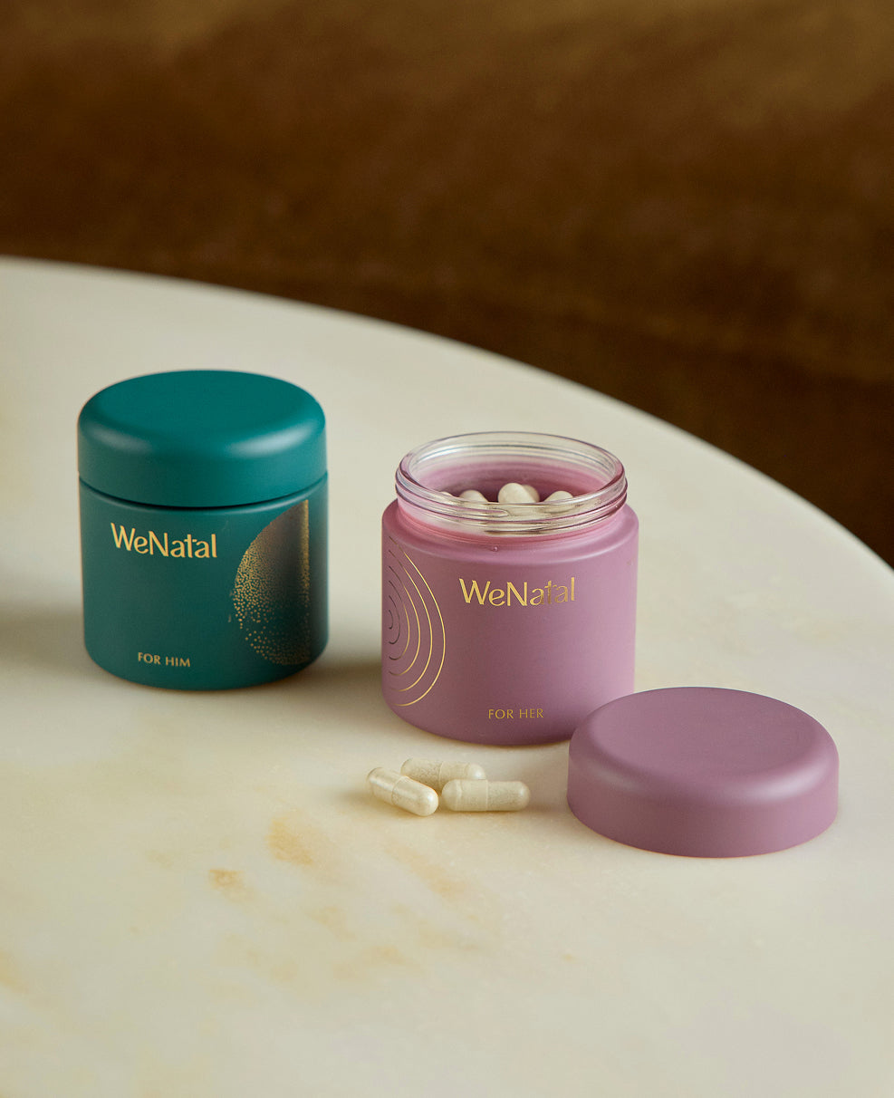 WeNatal Together Welcome Kit showcasing a teal and pink jar, each offering prenatal supplement capsules for men and women, highlighting daily and fertility support