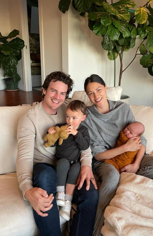 A family photo with the family sitting on the couch