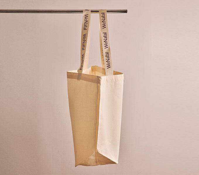 The WeNatal Tote, an unadorned canvas bag with WeNatal on handles, ideal for carrying daily prenatal supplements, supporting fertility and nutrient needs.