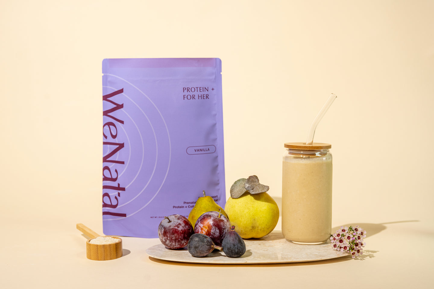 WeNatal Protein + for Her pouch with bamboo scoop, surrounded by pears, plums, figs, and a smoothie jar, highlighting its use in fruit-based shakes.
