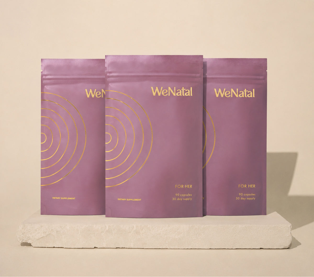 Three mauve WeNatal For Her prenatal supplement pouches, each a 30-day supply of 90 capsules.