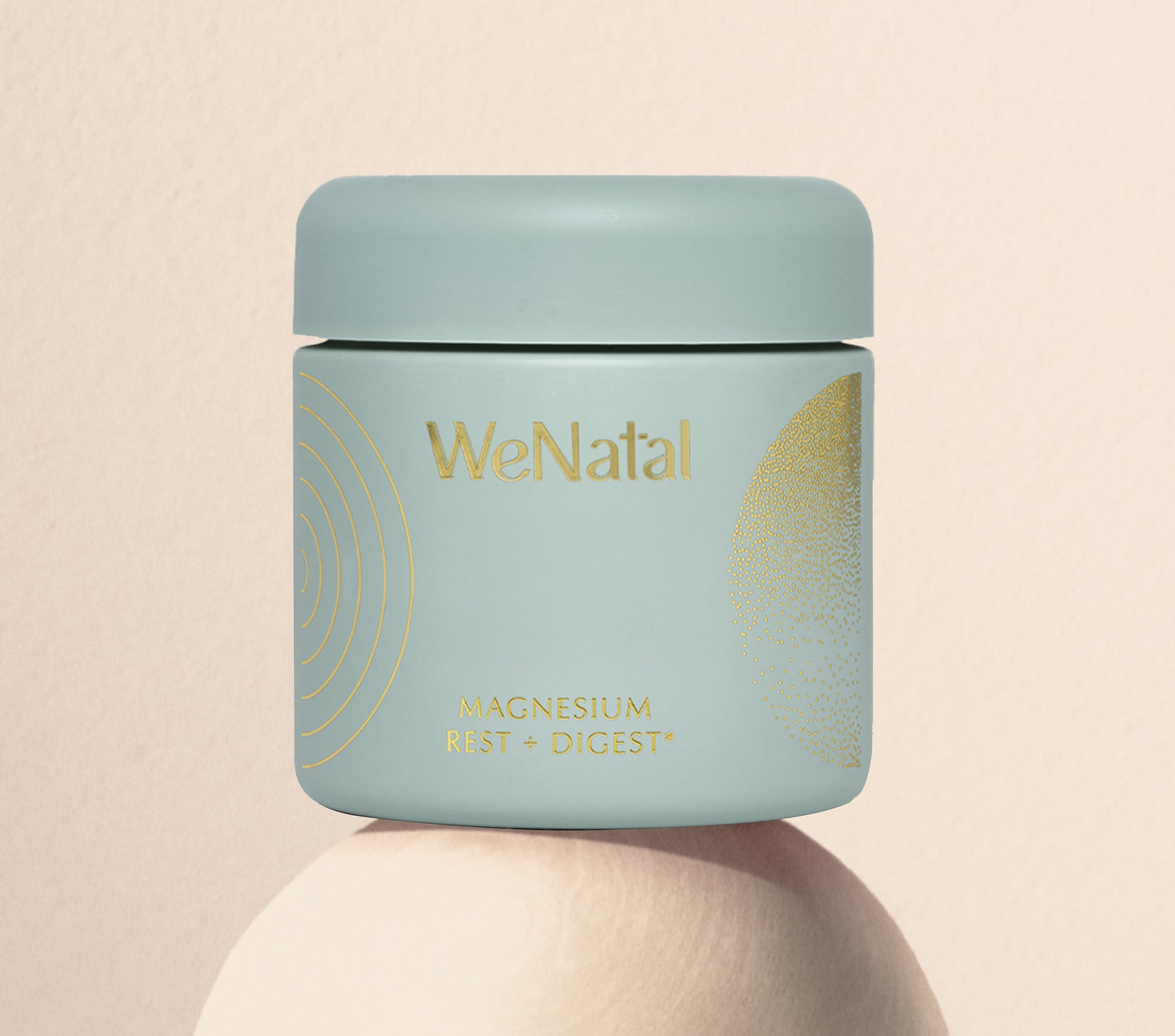 WeNatal Rest & Digest Magnesium Welcome Kit jar, featuring gold foil lettering, offering prenatal nutrient support and daily magnesium benefits, set on a smooth pedestal