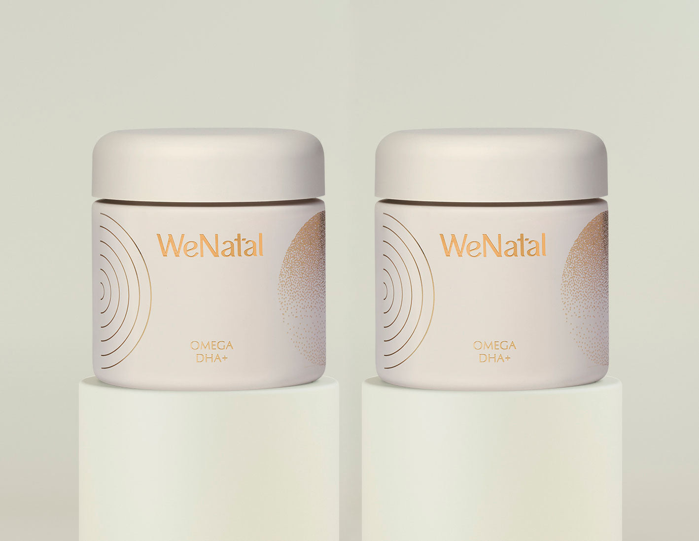 Two WeNatal Omega Together Welcome Kit jars, labeled OMEGA DHA+, sit on white plinths, highlighting a 30-day supply of prenatal supplements.